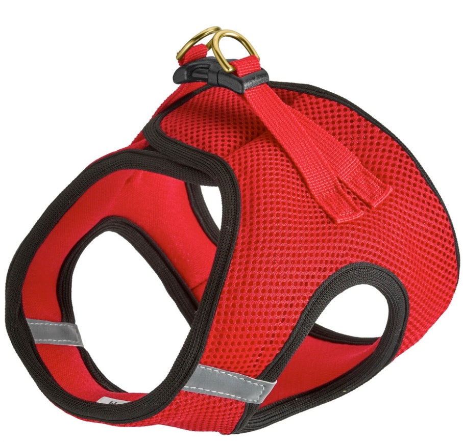 Red dog harness with black straps and reflective stripes on a white background
