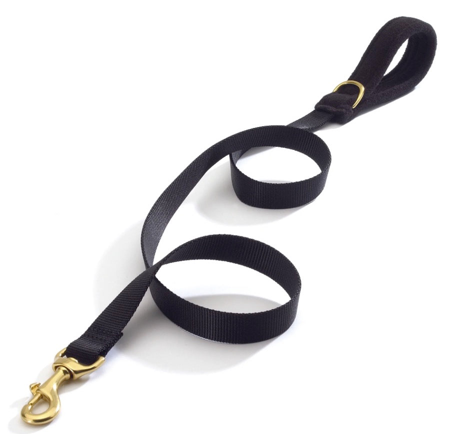 Black dog leash with gold clasp on a white background