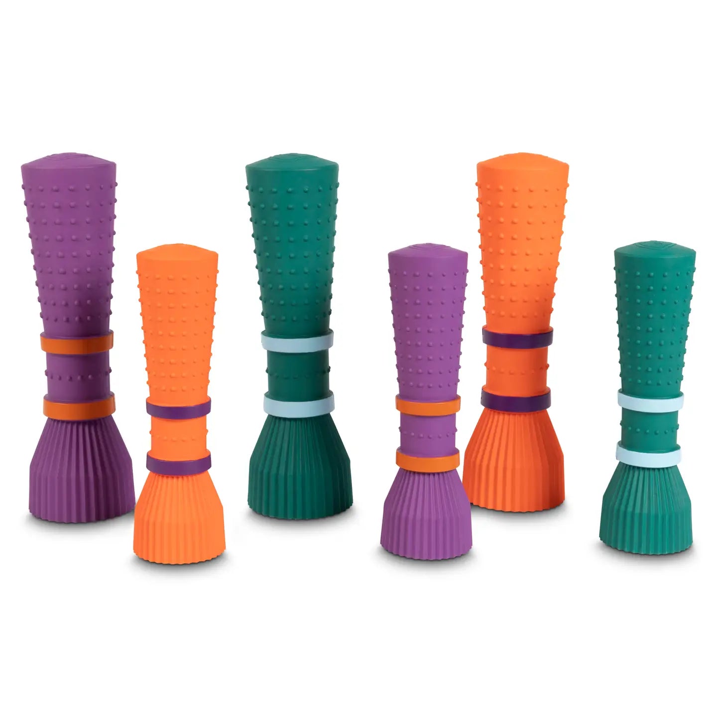 Set of colorful textured dog toys on a white background